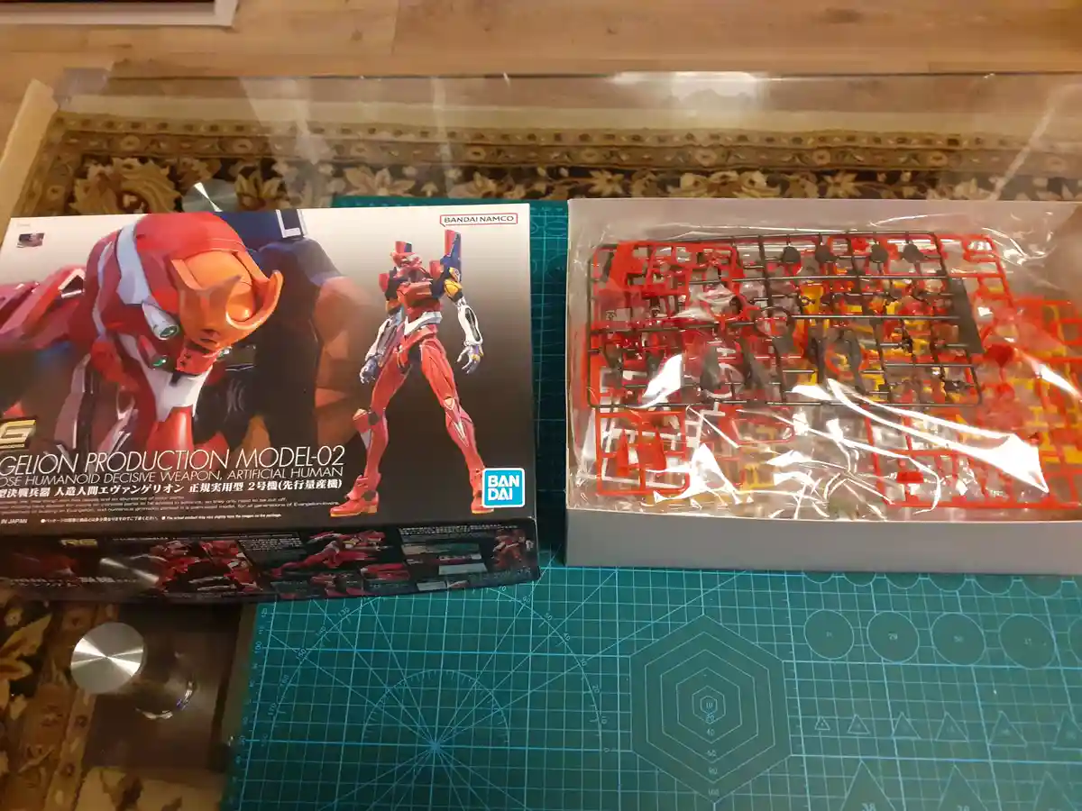 A photo shows the box for a Bandai Namco 'Gelion Production Model-02' plastic model kit next to its contents, which are…