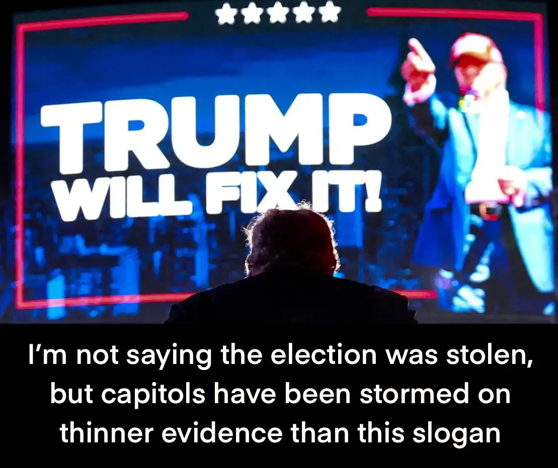 A person viewed from behind stands before a large screen displaying a man in a blue suit and red cap pointing, with the text…