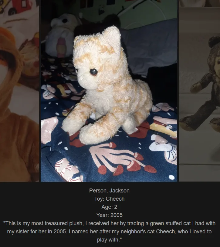 A slightly worn, light orange and white striped plush cat sits upright on a dark blue patterned blanket. Below the image…