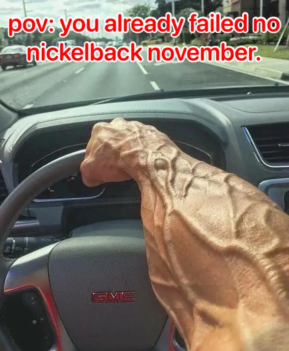 A photo from inside a car shows a massively muscular arm gripping the steering wheel, with the GMC logo visible on the…