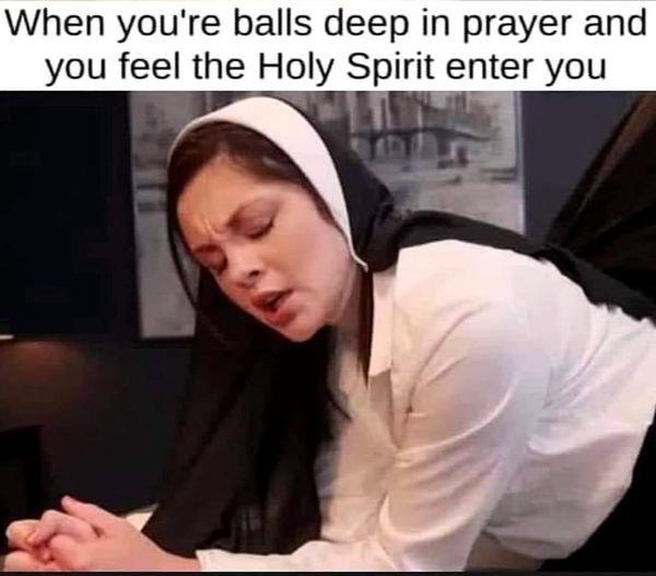 A woman wearing a white and black nun's habit is shown kneeling with her hands clasped, eyes closed, and face contorted in…
