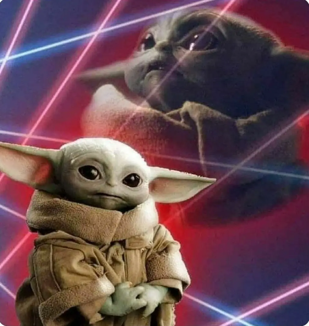A small, pale green baby Yoda (Grogu) in a brown robe stands in the foreground with arms crossed and a pouty expression…