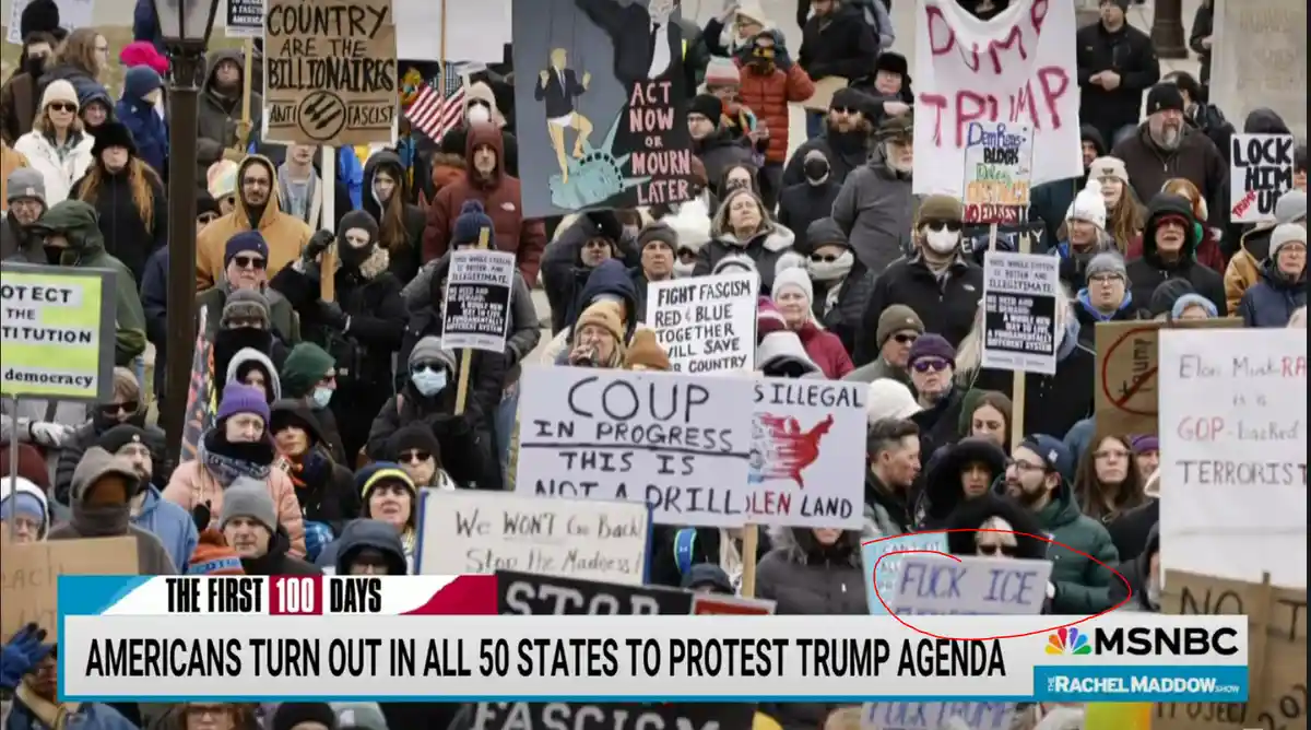 A crowd of protesters holding various signs against Trump, including 'COUP IN PROGRESS THIS IS NOT A DRILL' and 'Dump…
