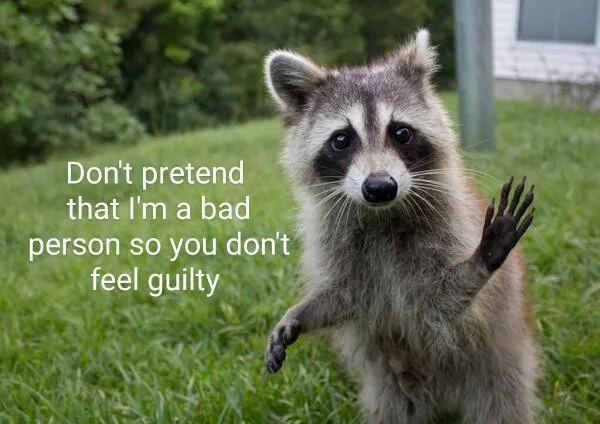 A raccoon stands upright on grass, one paw raised as if waving or gesturing, looking directly at the camera. White text…