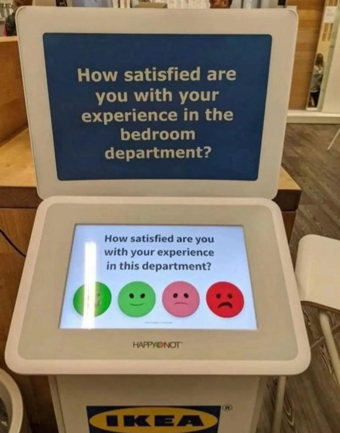 An IKEA customer satisfaction kiosk displays a survey asking 'How satisfied are you with your experience in the bedroom…