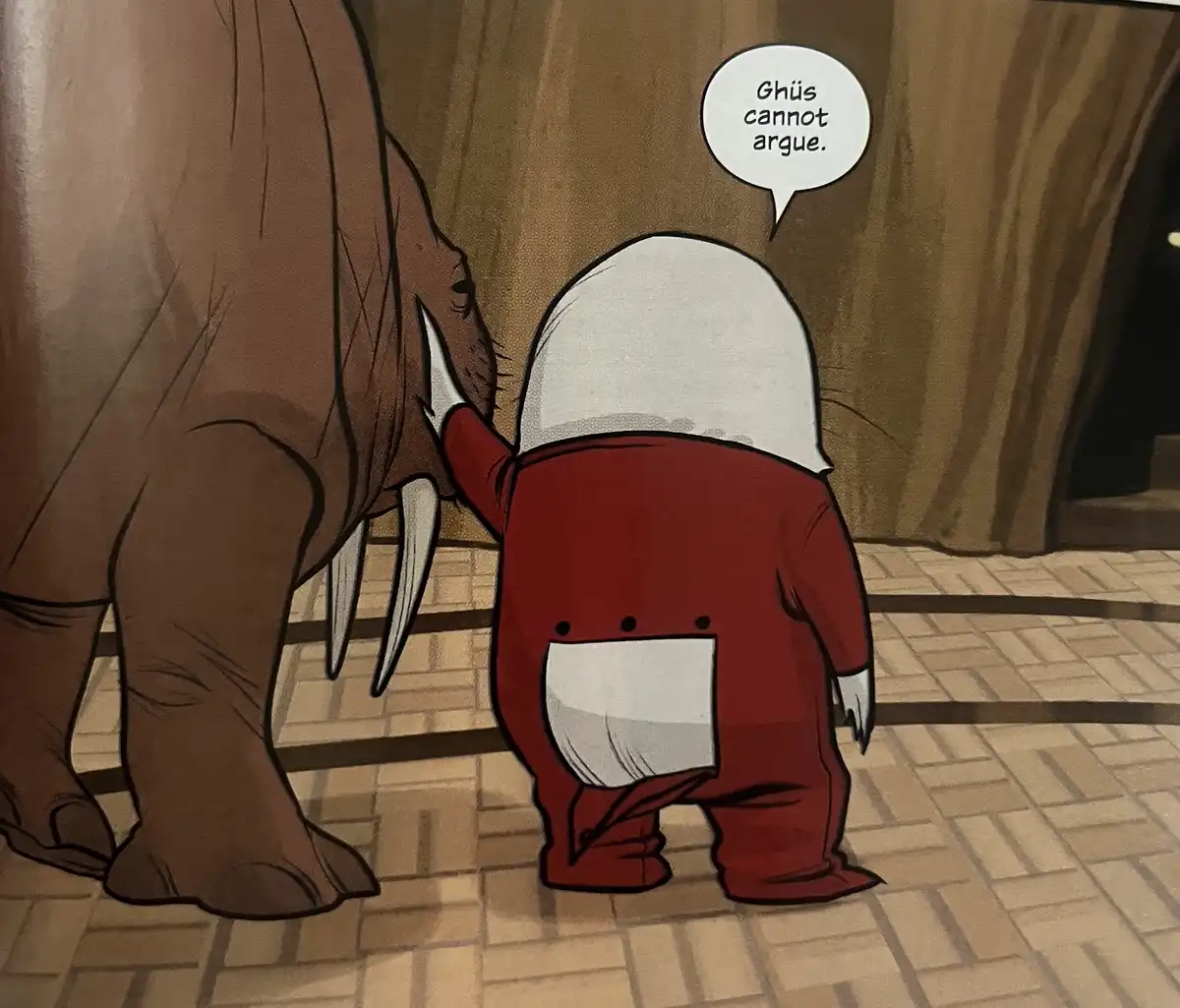 A small, red, cartoonish character with a white hood and a white square on its back stands facing away from the viewer…