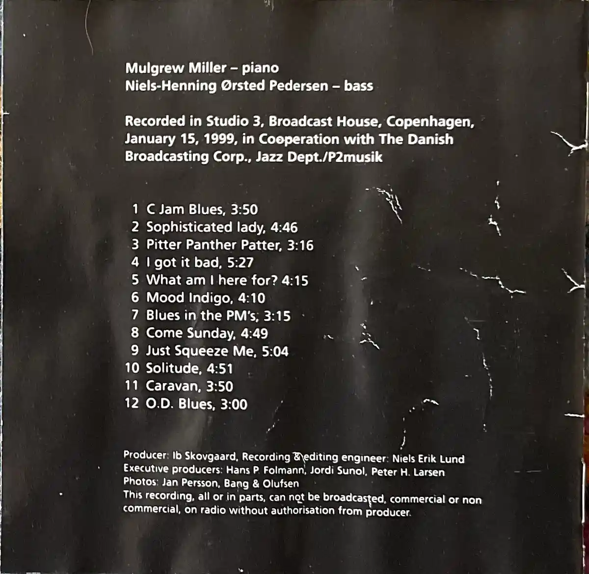 The image shows the back cover of a jazz album with white text on a dark background, listing musicians, recording details…