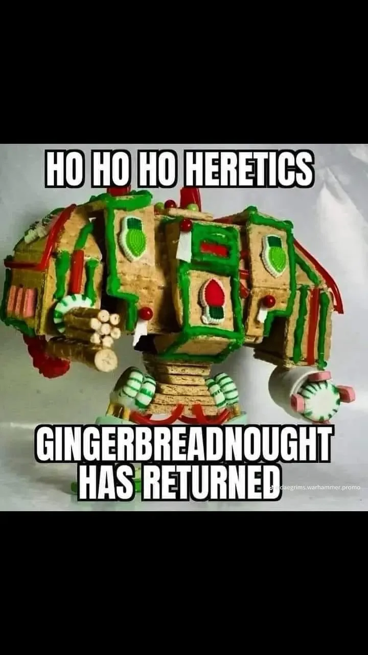 A large, intricate gingerbread model of a Warhammer 40k vehicle, decorated with green and red icing, candy details, and…