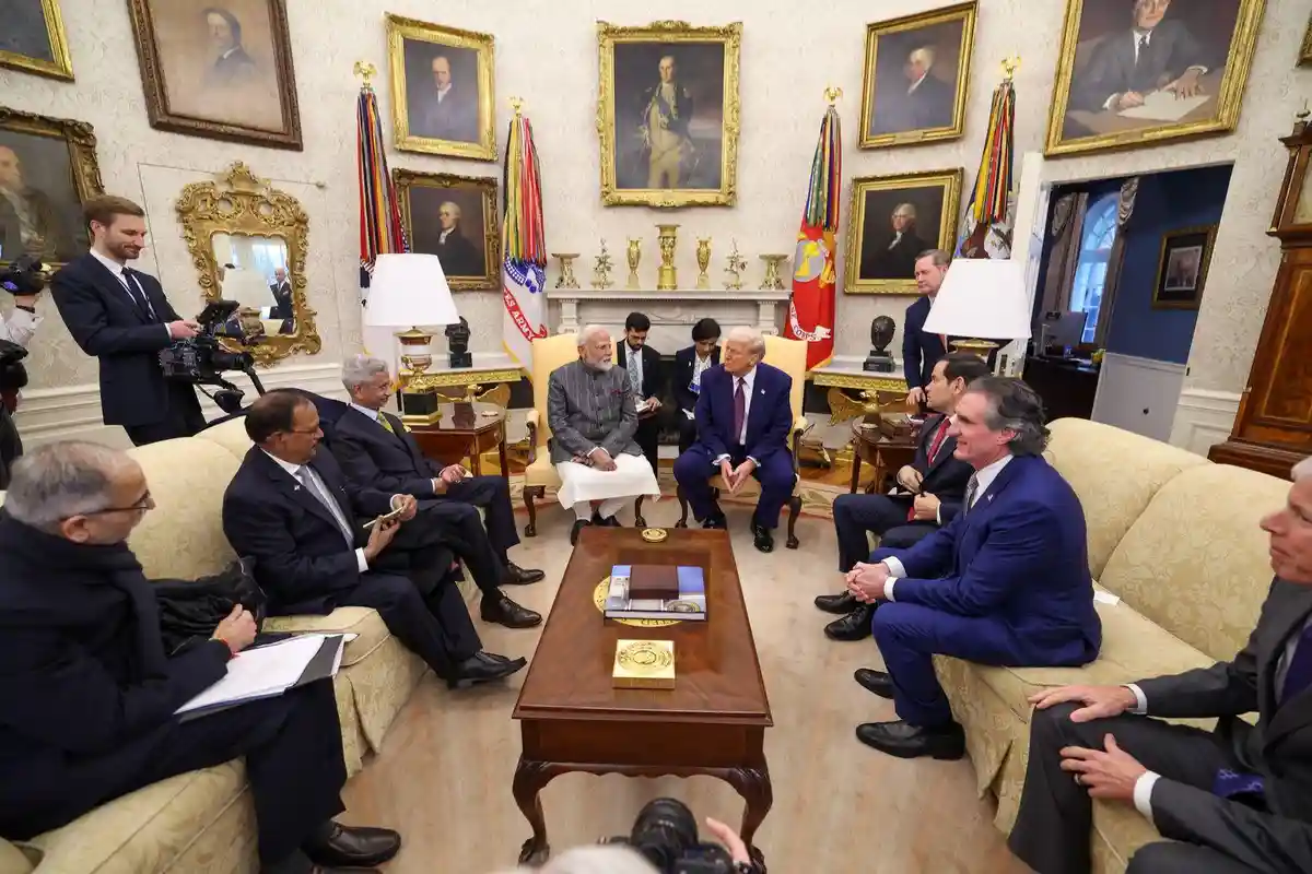 a formal meeting of world leaders in the oval office, with numerous men in suits seated around a coffee table, but the…