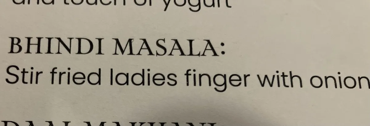 A close-up of a printed recipe page showing the dish 'BHINDI MASALA' with the instruction 'Stir fried ladies finger with…
