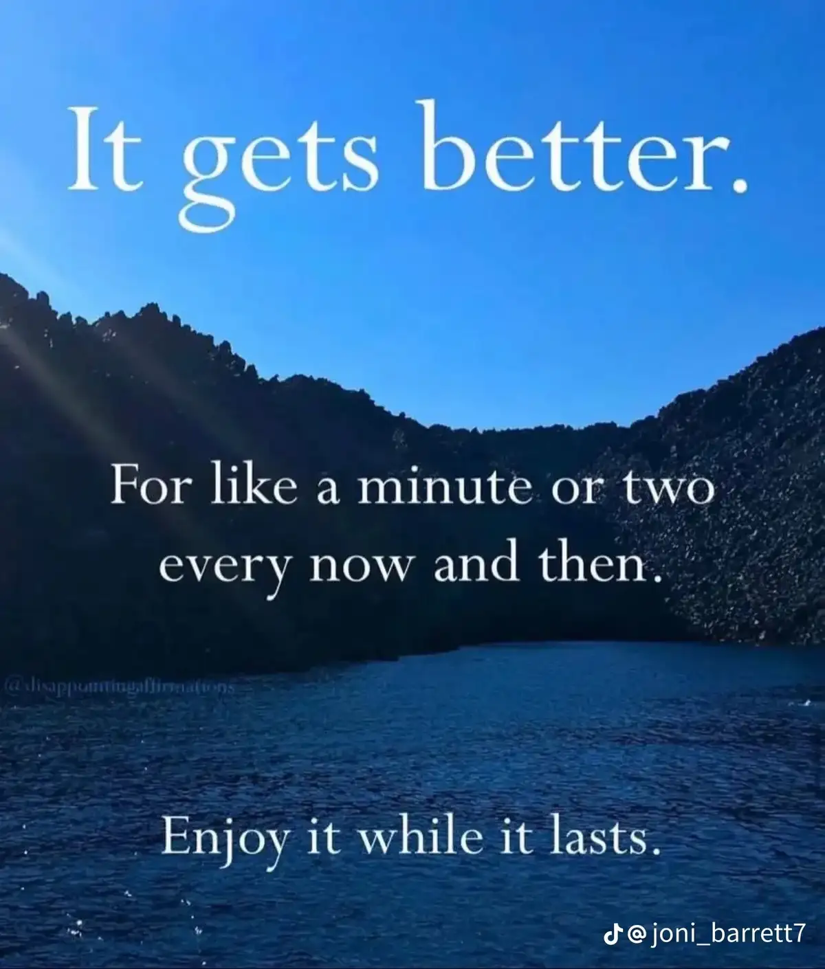 A serene blue sky and water landscape with dark hills, overlaid with white text that reads 'It gets better. For like a…