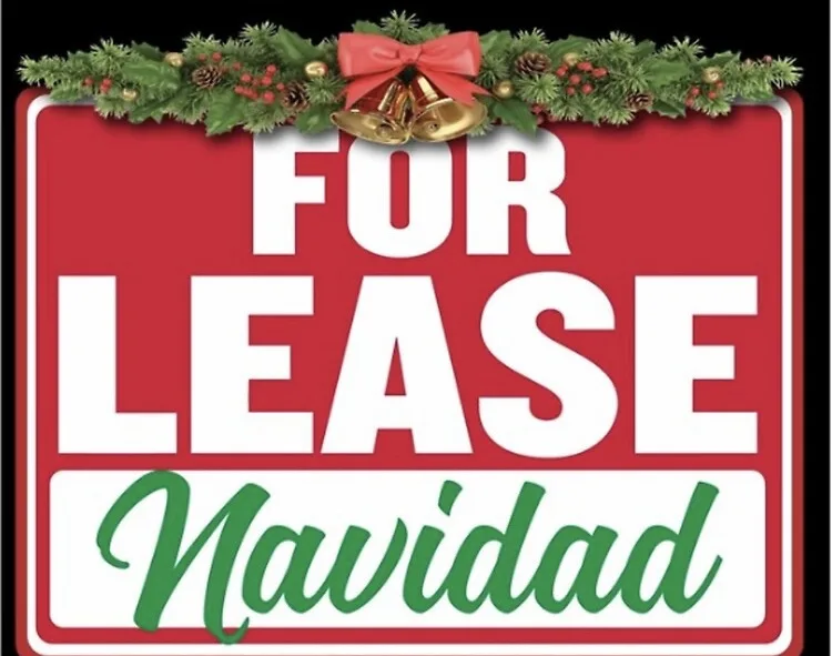 A red 'For Lease' sign decorated with Christmas garland, pinecones, red berries, and golden bells, with the word 'Navidad'…
