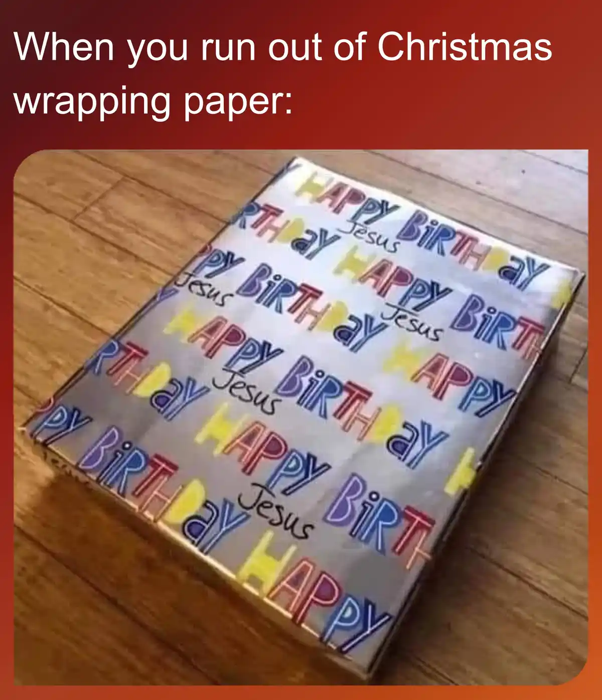 A gift box wrapped in birthday-themed paper featuring repeated 'Happy Birthday Jesus' text in colorful fonts, placed on a…