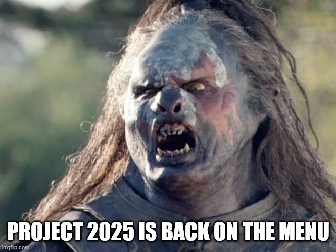 A close-up image of a grotesque, pale-skinned, long-haired humanoid creature with a snarling, angry expression, baring sharp…