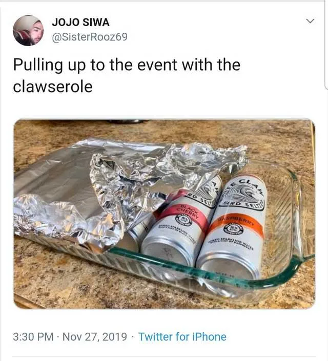 A glass baking dish on a granite countertop contains two cans of 'The Claw' hard seltzer (Black Cherry and Blackberry…