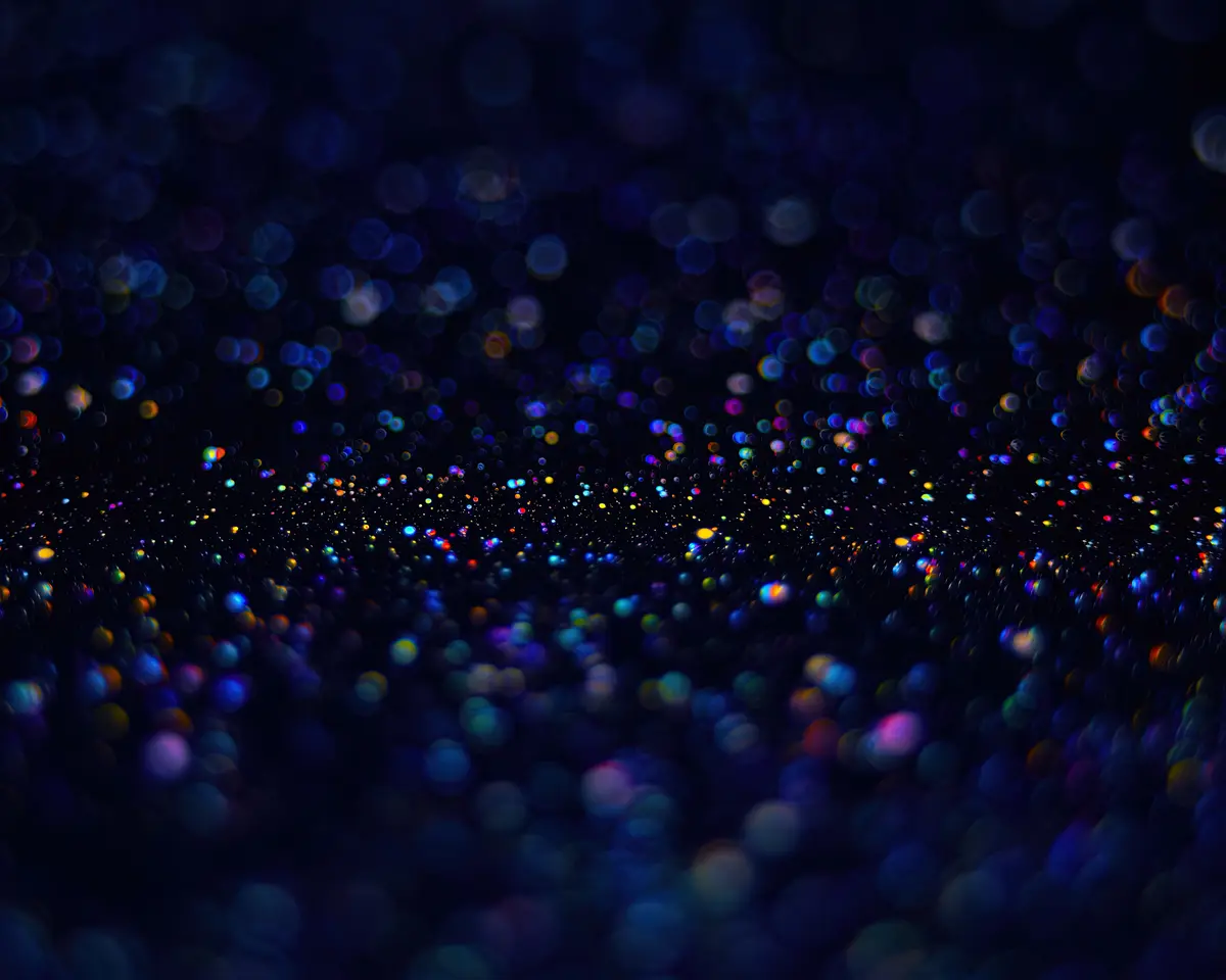 An abstract image of a dark tunnel or pathway formed by countless out-of-focus, colorful circular lights, resembling bokeh…