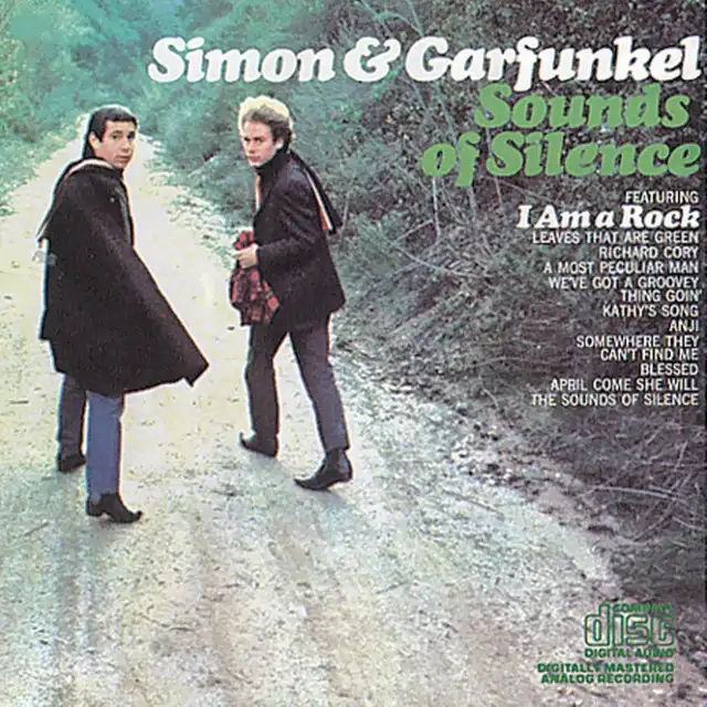 The image is the album cover for Simon & Garfunkel's 'Sounds of Silence,' showing the two musicians walking on a dirt path…
