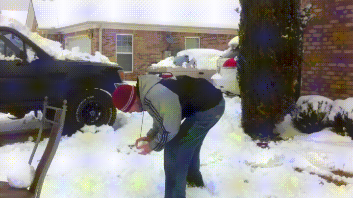 A six-panel image sequence shows a man in a red beanie and jacket building a snowball, then throwing it at another man in a…