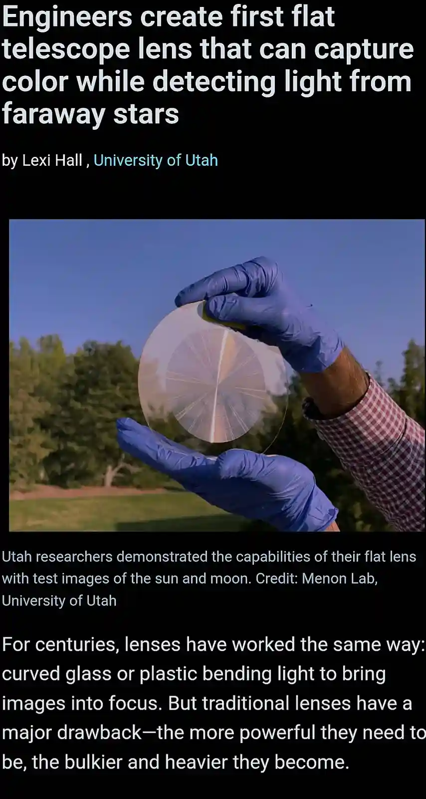 A person wearing blue gloves holds a thin, circular, flat lens with radial grooves against a blue sky and green trees. The…