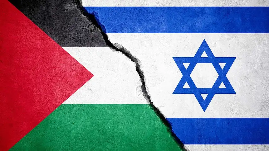 The image shows the flags of Palestine and Israel painted on opposite sides of a cracked concrete wall, with the crack…