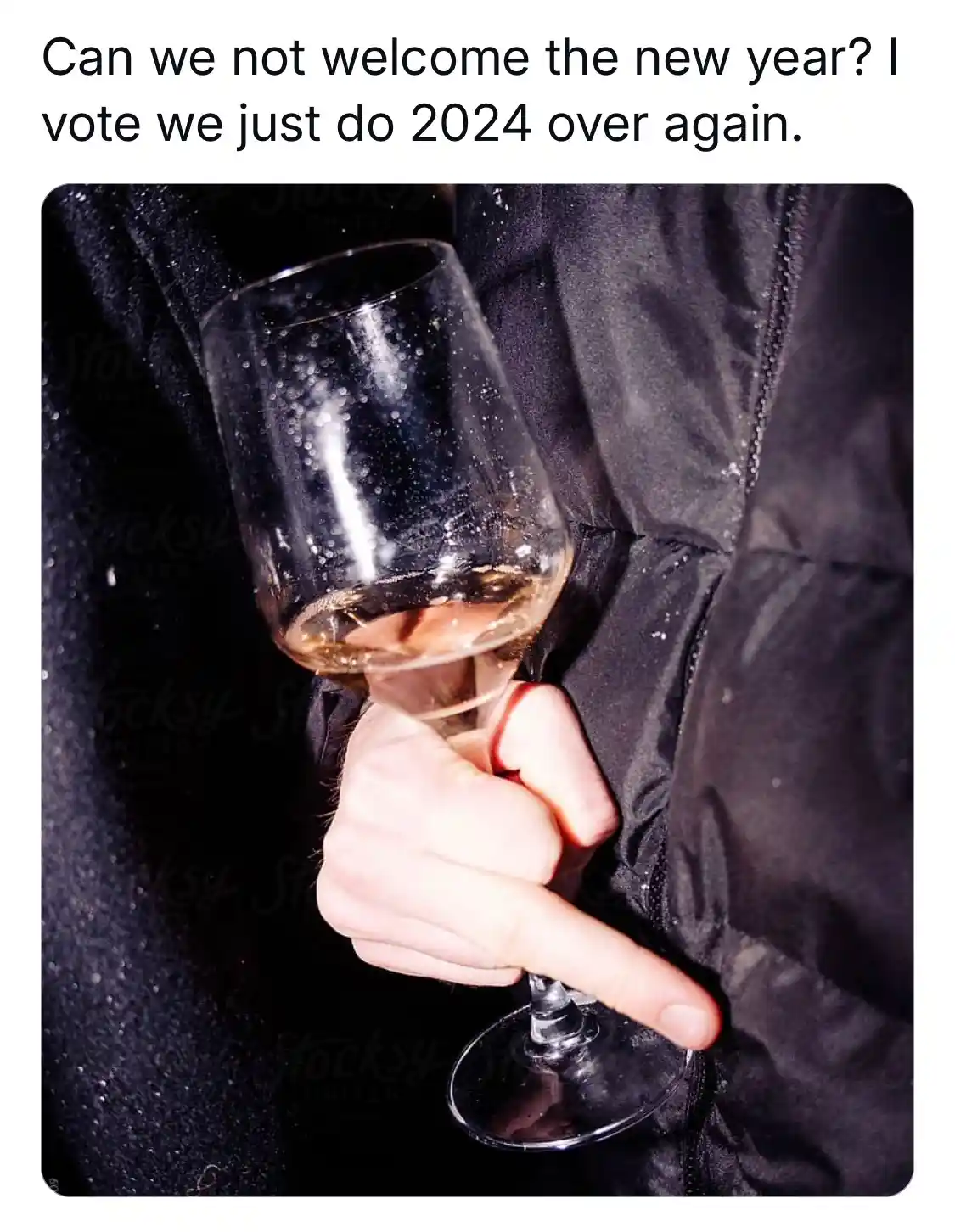 A close-up image shows a person's hand gripping a wine glass with a small amount of liquid remaining, set against a dark…