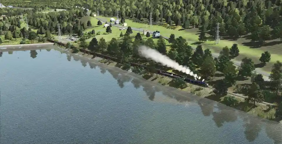 A screenshot from a train simulation game shows a steam locomotive pulling a long train along a track beside a large body of…