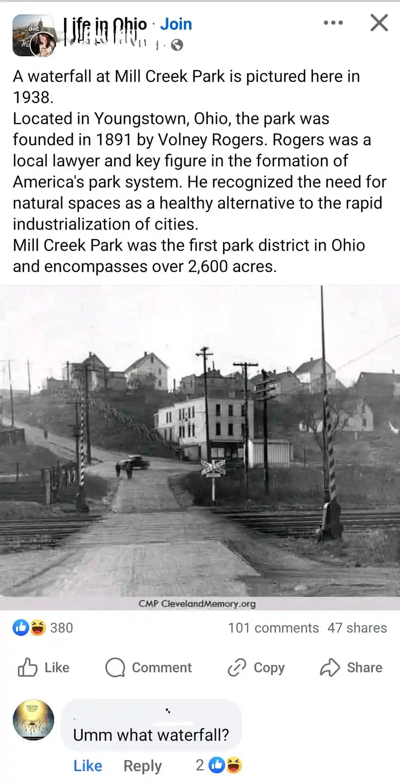 A black-and-white historical photo from 1938 shows a street scene in Youngstown, Ohio, with houses on a hill, train tracks…