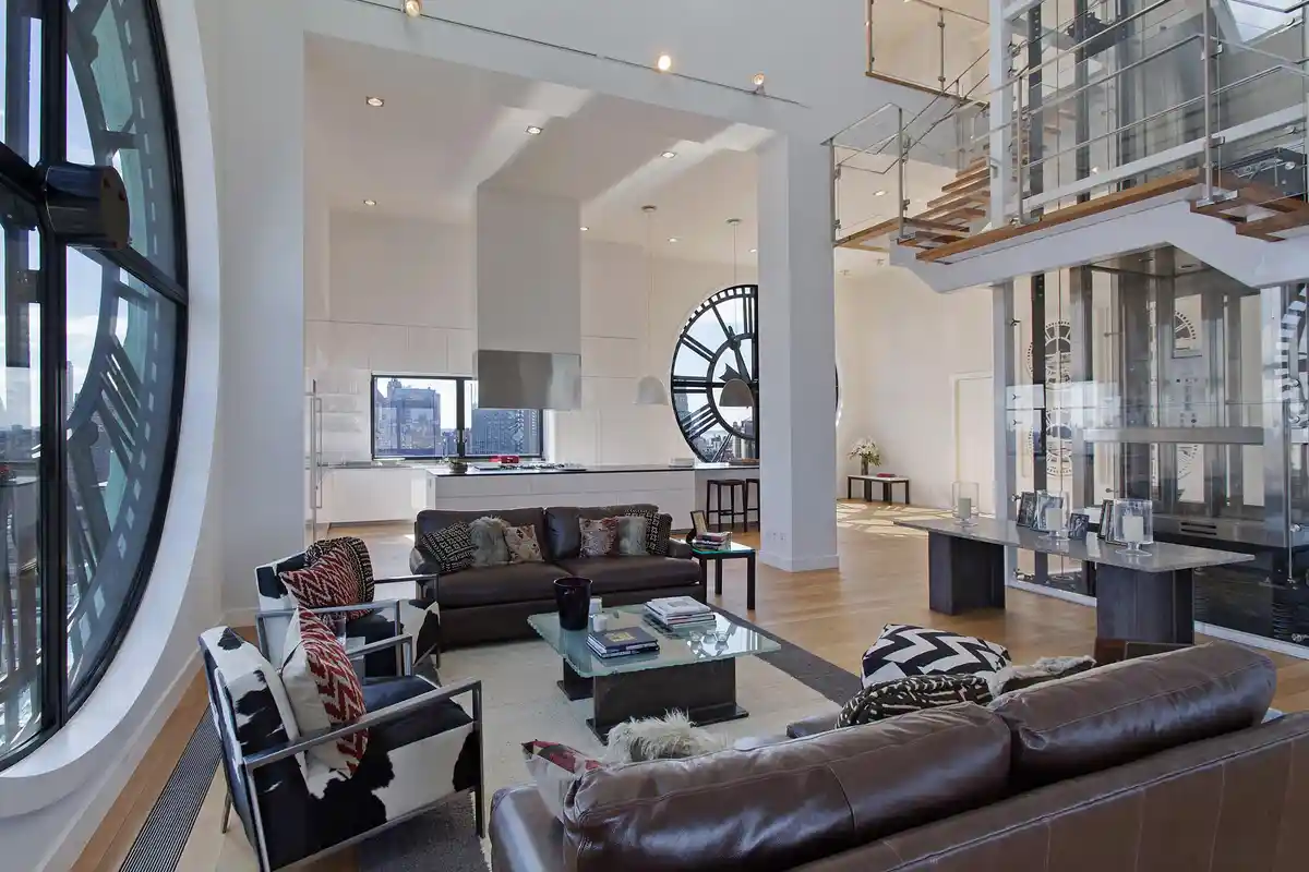 A luxurious, modern, open-concept apartment with high ceilings, hardwood floors, and large windows. The living area features…