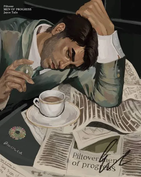 A man in a green jacket and white shirt is asleep at a desk, head resting on his hand, with a cup of coffee and scattered…