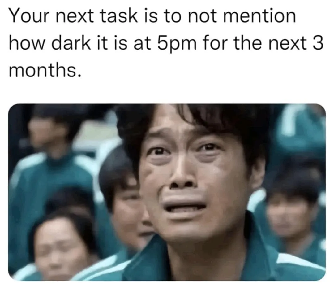 A close-up image of a man in a teal tracksuit with a distressed, tearful expression, surrounded by other similarly dressed…