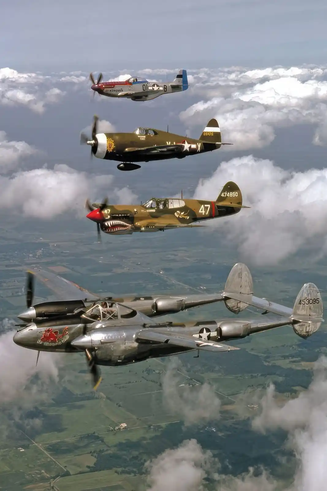 Four vintage military aircraft fly in formation above clouds and green fields. From top to bottom: a P-51 Mustang, a P-47…
