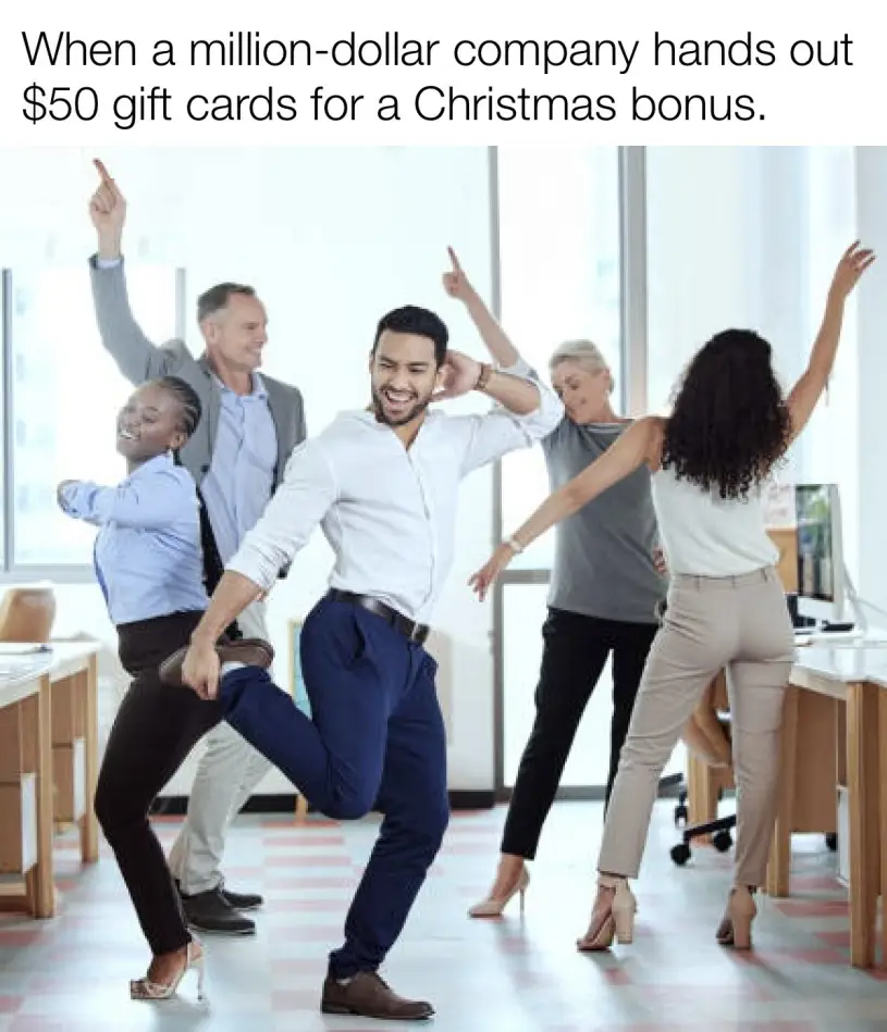 A group of five office workers joyfully dancing in an open-plan office, arms raised and smiling, celebrating what appears to…