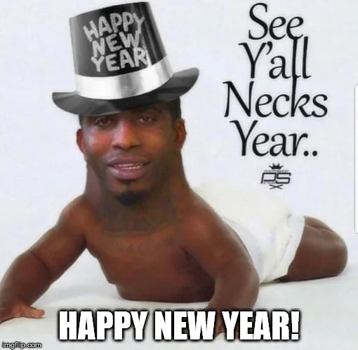 A shirtless Black man wearing a black top hat with 'HAPPY NEW YEAR' written on it, lying on his stomach on a white surface…