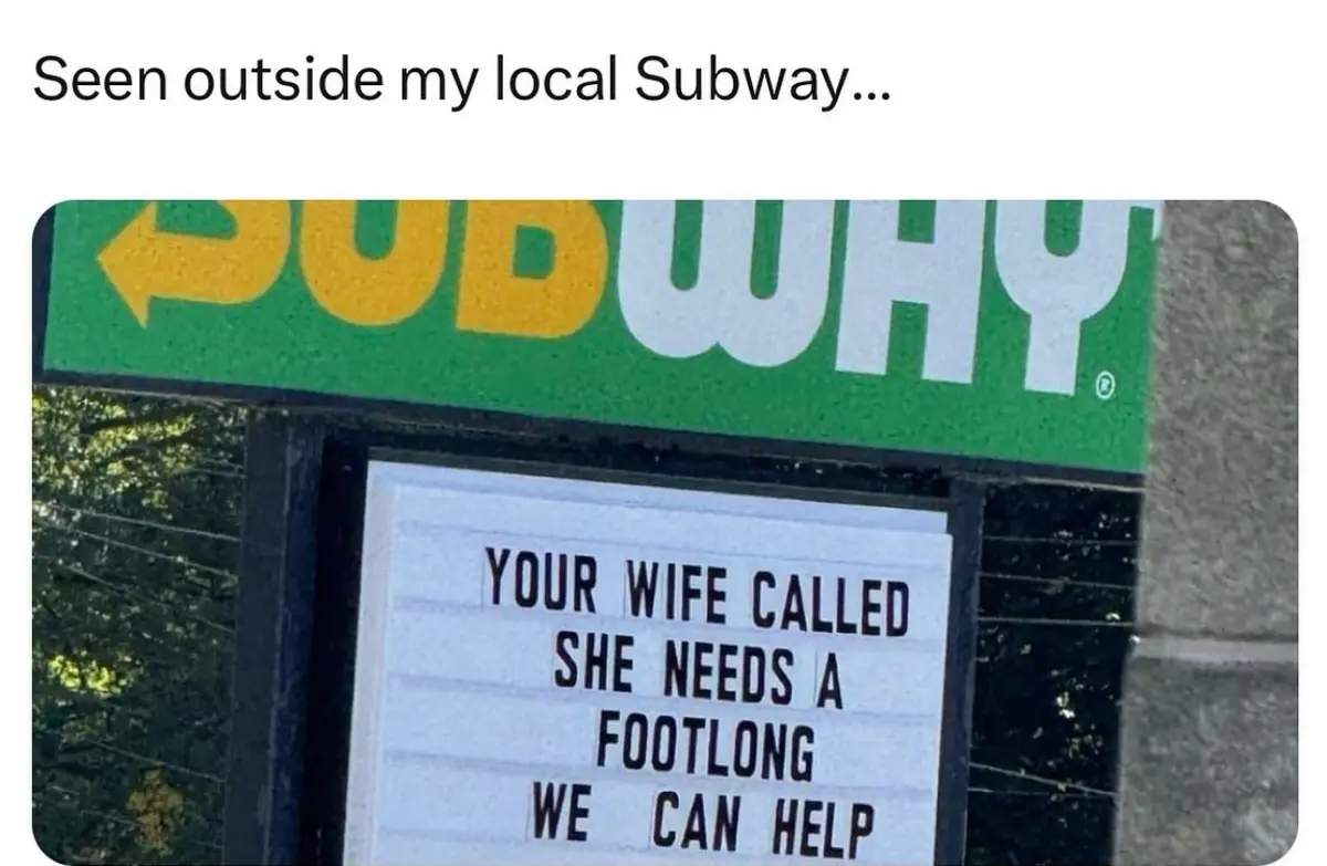 A photo shows a Subway restaurant sign with a white marquee board below it. The board displays the text 'YOUR WIFE CALLED…