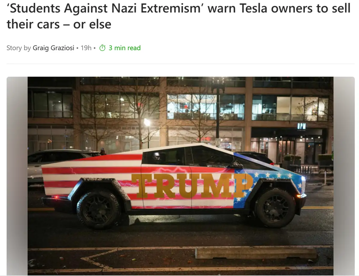 A Tesla Cybertruck is parked on a city street at night, wrapped in a patriotic American flag design with the word 'TRUMP' in…