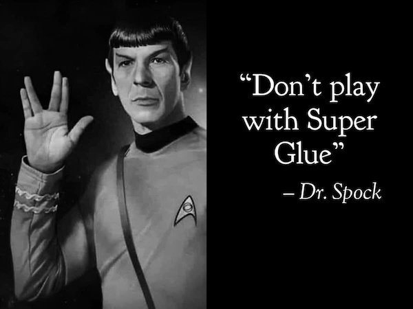 A black-and-white image of the Star Trek character Spock, wearing his uniform and raising his hand in the Vulcan salute. To…