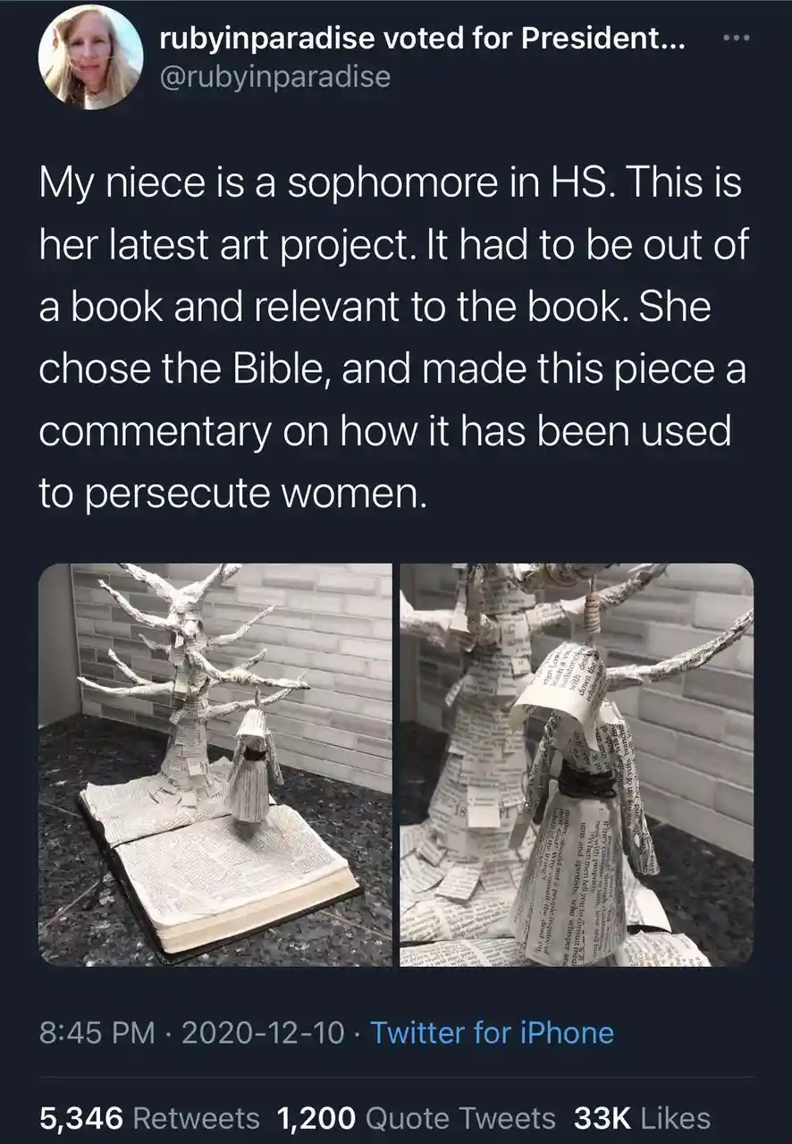 A tweet shows two photos of an art project made from pages of an open Bible. The project depicts a tree with a figure…