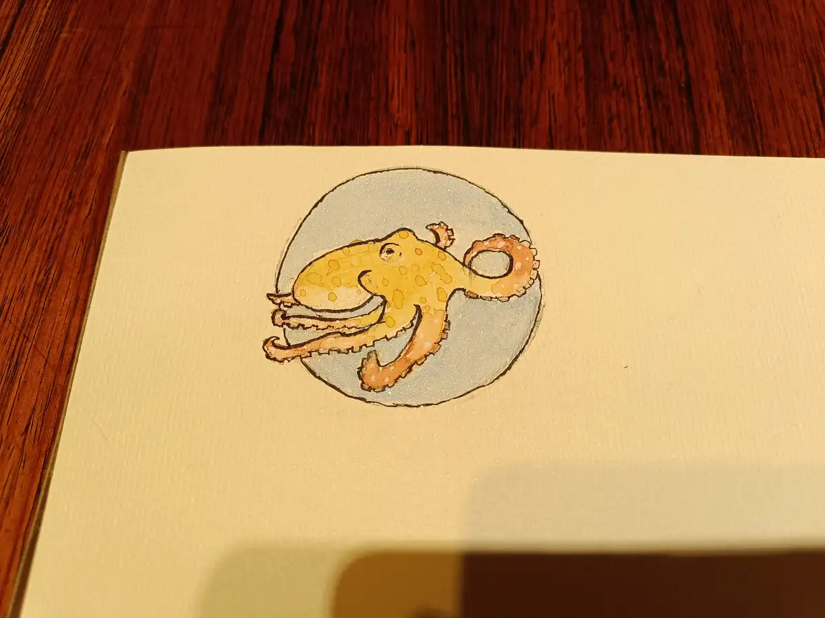 A hand-drawn illustration of a yellow, smiling octopus with brown spots, curled inside a light gray circle on textured cream…