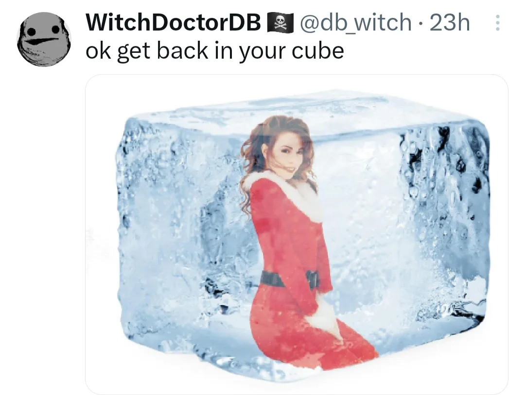 A woman in a red Santa-style outfit is encased in a large, clear ice cube. The image is overlaid with the text 'ok get back…