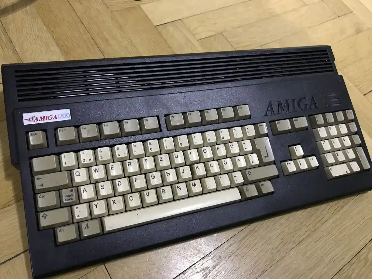 A close-up photo of a vintage Amiga 1200 computer keyboard, showing its distinctive layout and beige keys, resting on a…