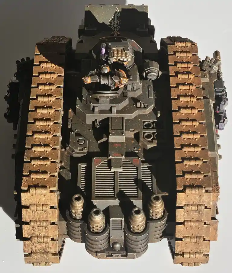 This is a top-down photograph of a highly detailed, custom-painted Warhammer 40,000 tank model, likely a Tyrant or similar…