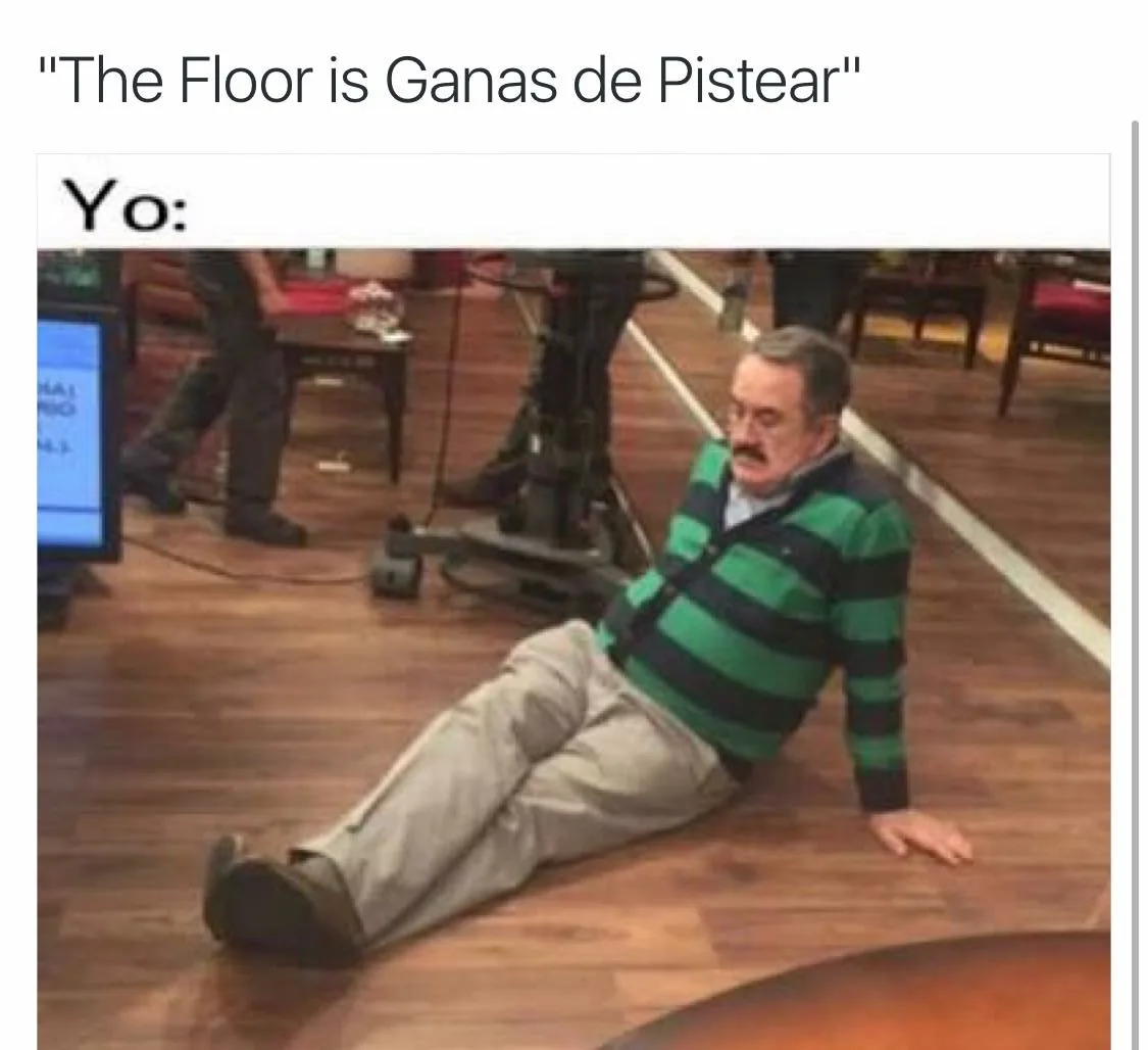 A man in a green and black striped sweater and beige pants is slumped on a wooden floor, looking defeated. The text above…