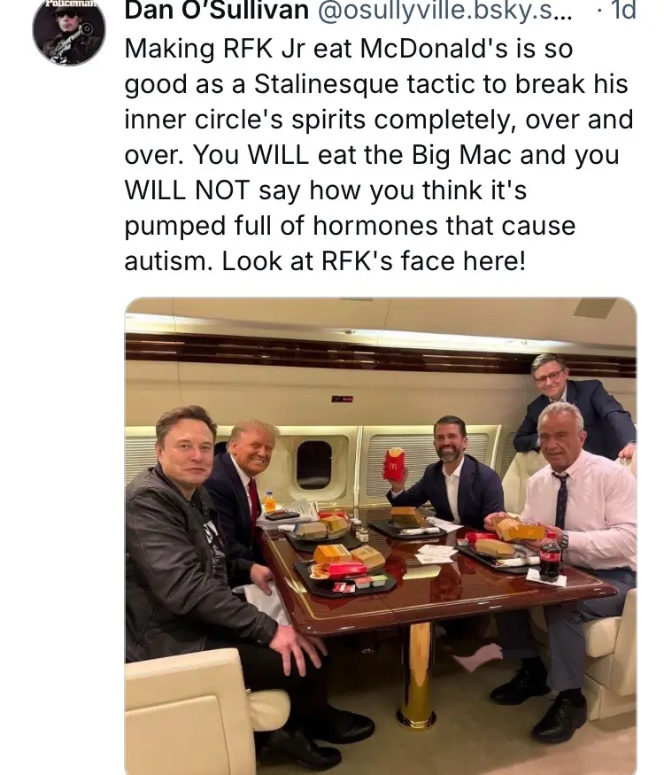 Five men are seated around a polished wooden table inside a private jet, eating McDonald's meals. Elon Musk, Donald Trump…