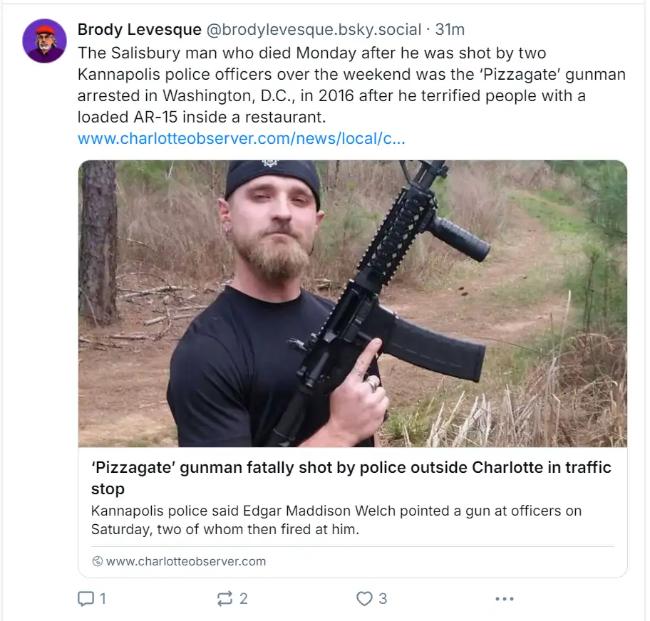 A screenshot of a social media post showing a man with a beard and black cap holding an AR-15 rifle outdoors. The post's…