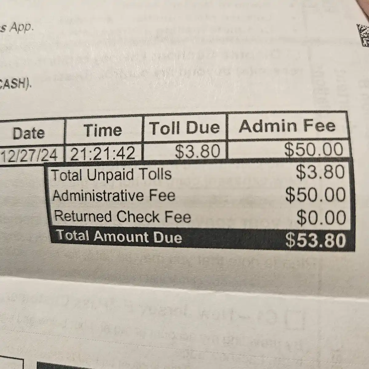 A close-up of a toll invoice showing a $3.80 toll due and a $50.00 administrative fee, resulting in a total amount due of…
