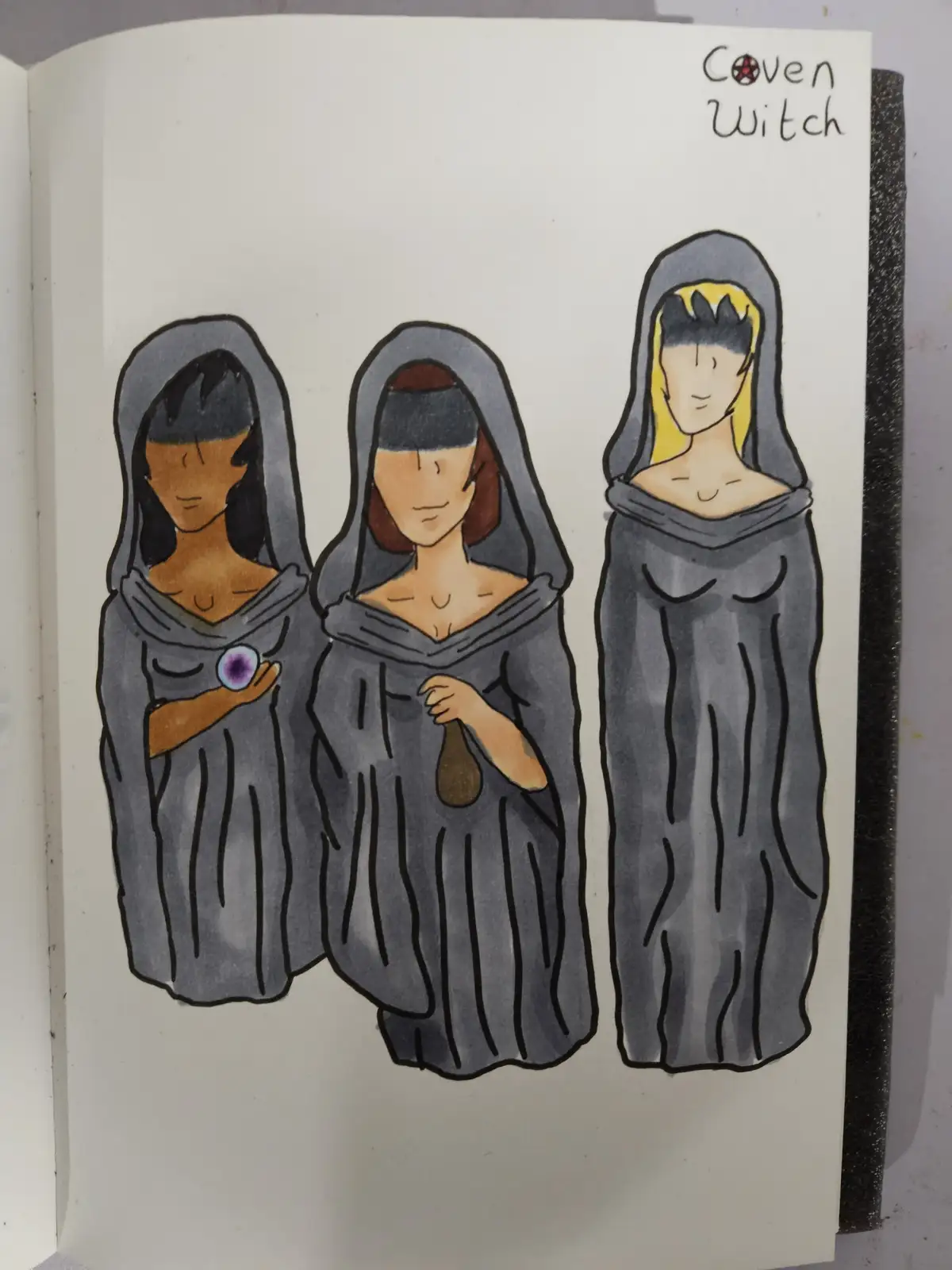 A hand-drawn illustration in a sketchbook shows three women in grey hooded robes, labeled 'Coven Witch' at the top. The…
