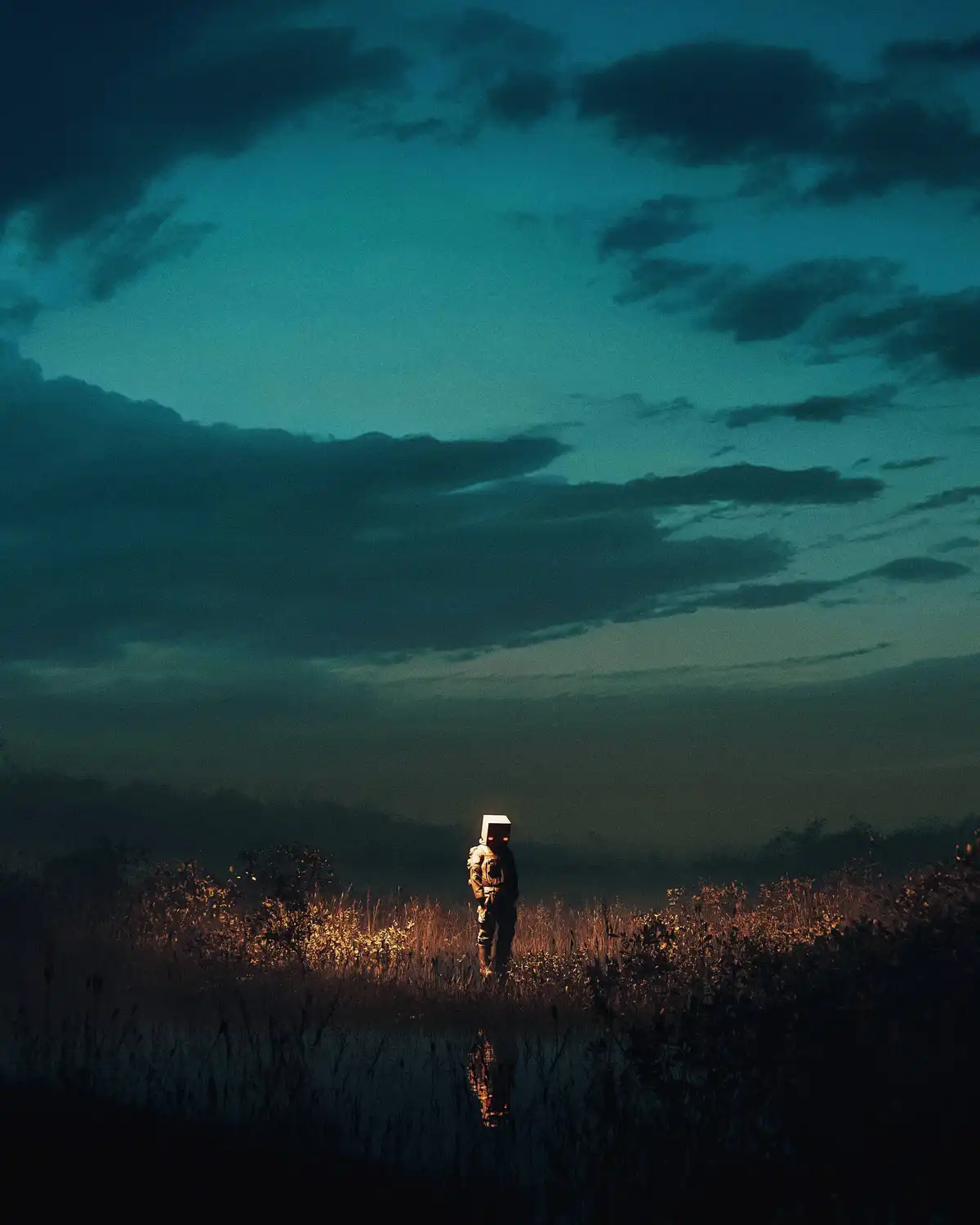 A lone figure stands in a field at dusk, wearing a glowing, boxy helmet with red eyes, silhouetted against a moody teal sky…