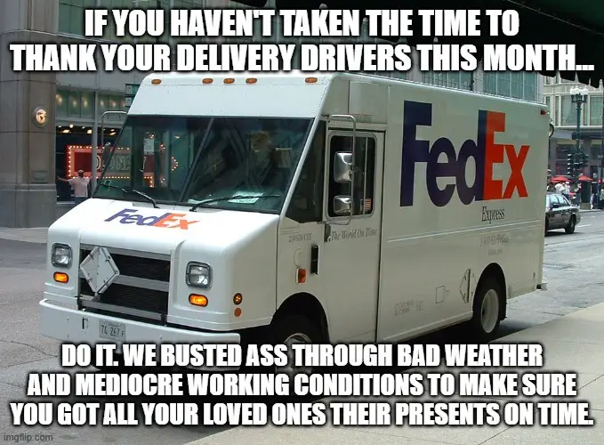 A white FedEx delivery truck is parked on a city street, with the company's logo visible on the side and front. The image…