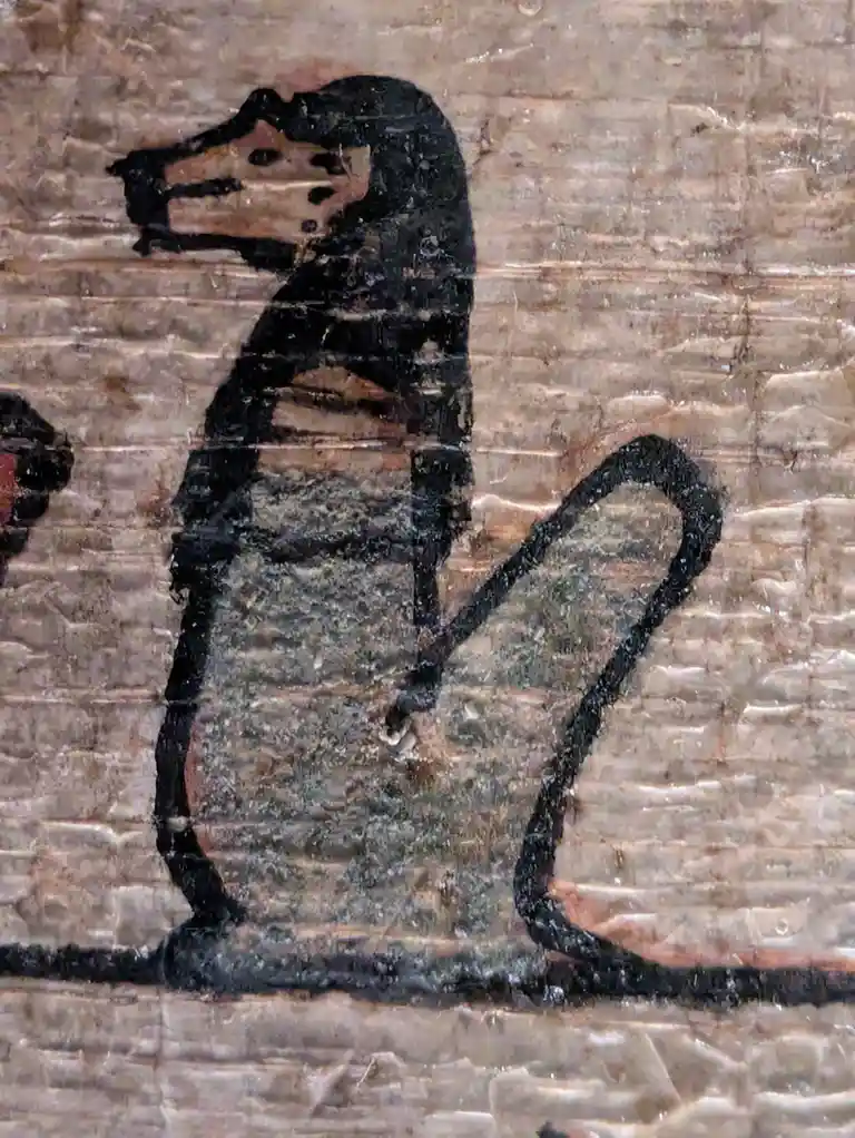 A crudely drawn black outline of a horse on a textured, light-brown brick wall, with its head replaced by a slice of Swiss…
