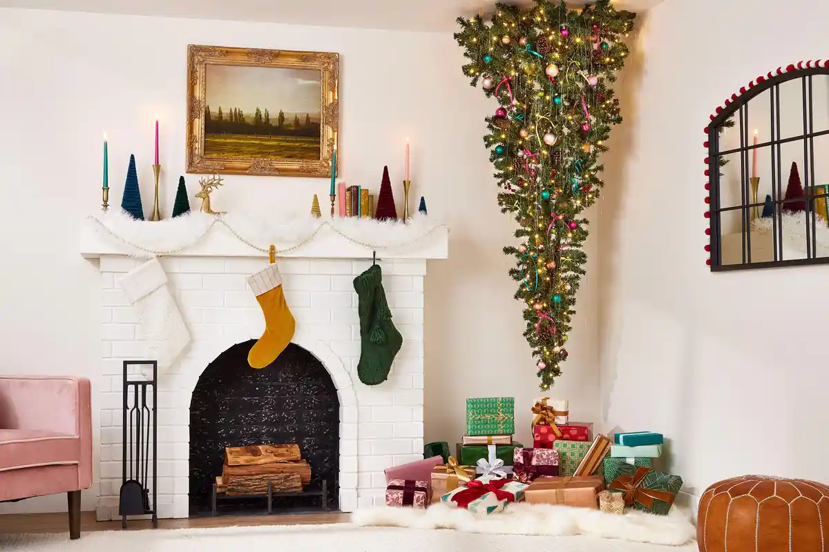 A lavishly decorated Christmas scene features a white brick fireplace with stockings, candles, and a mantel adorned with…